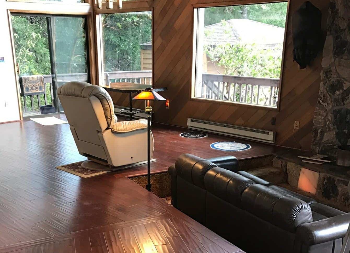 Finished great room with tall wood-framed windows